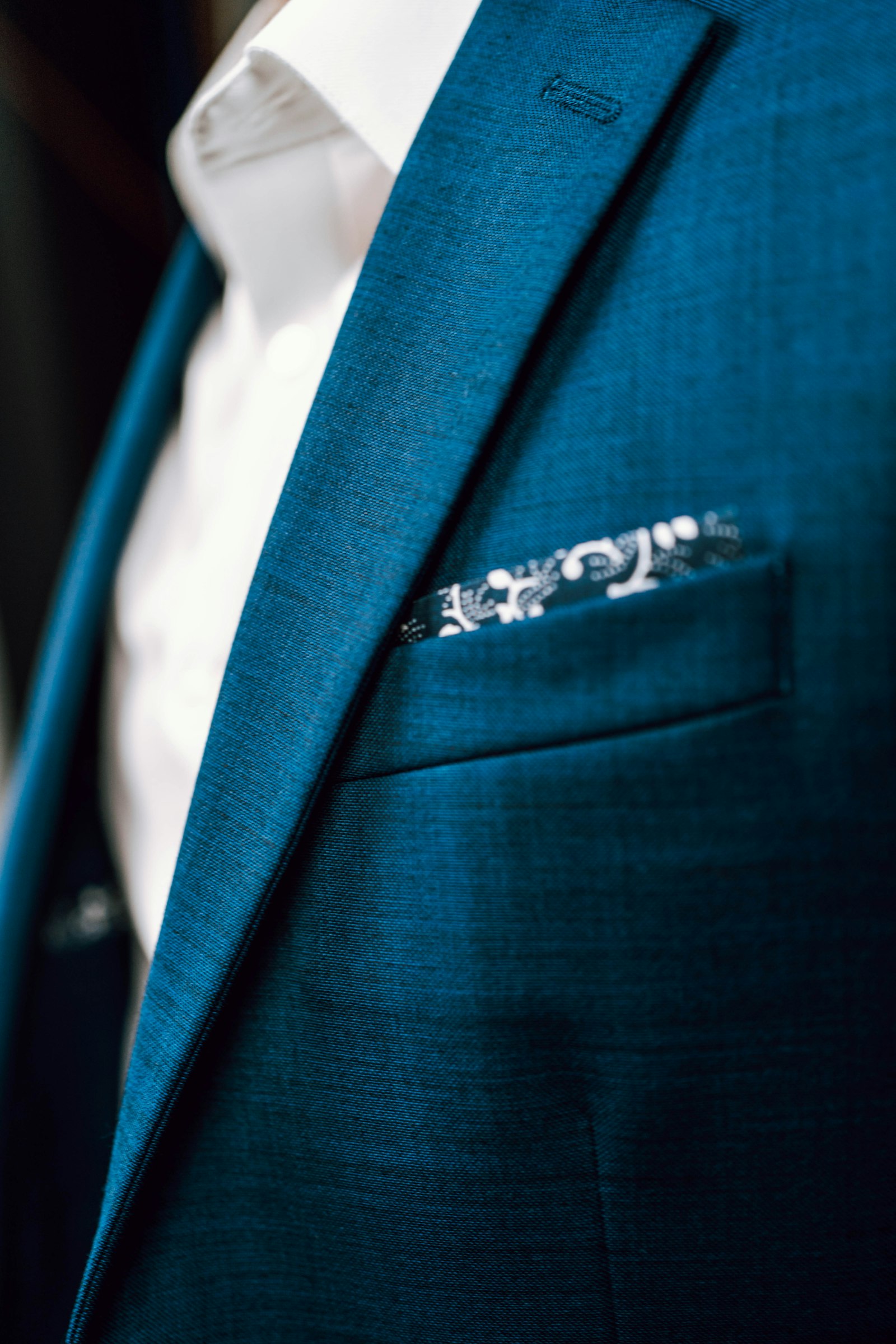 Teal jacket lapel with a pocket square