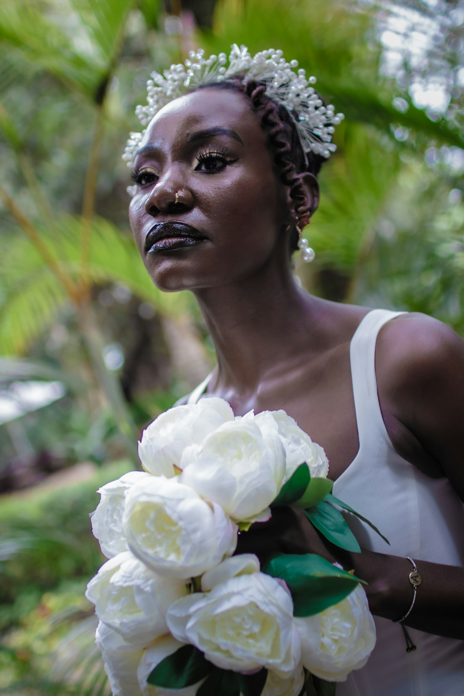 Bride holding white silk peonies