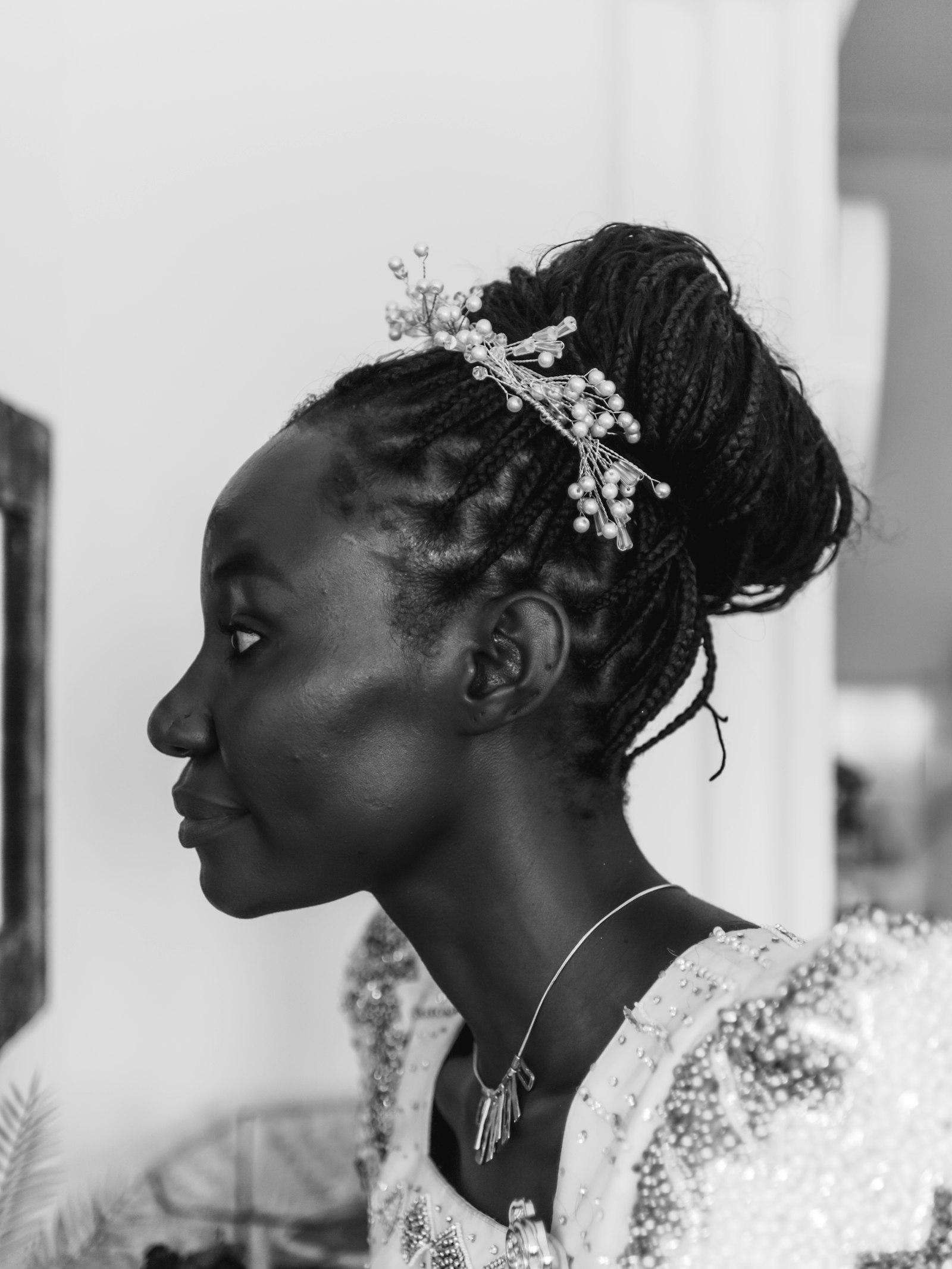 Bride in profile wearing the pearl crown on a high bun