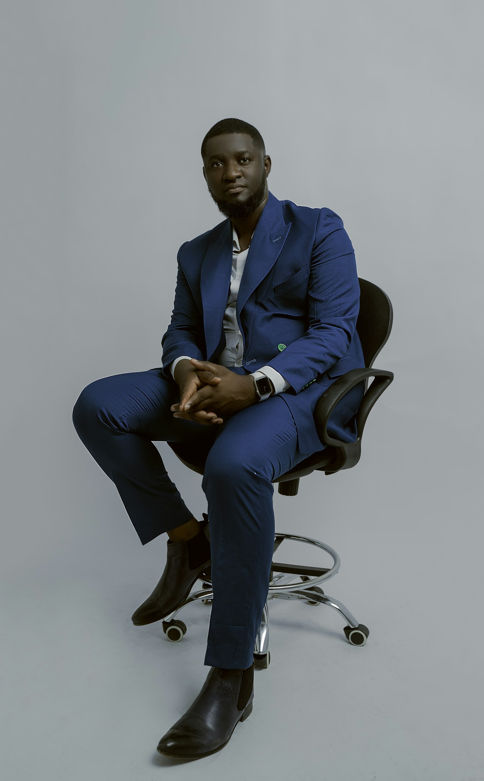 Navy suit, seated