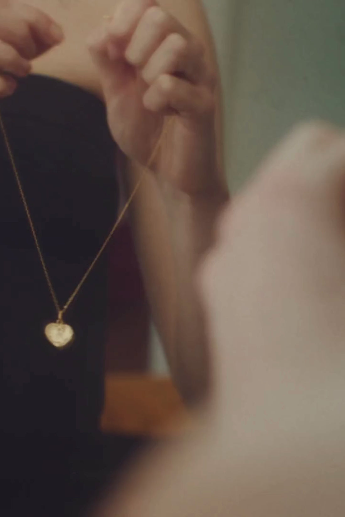 A gold pendant in deep red light