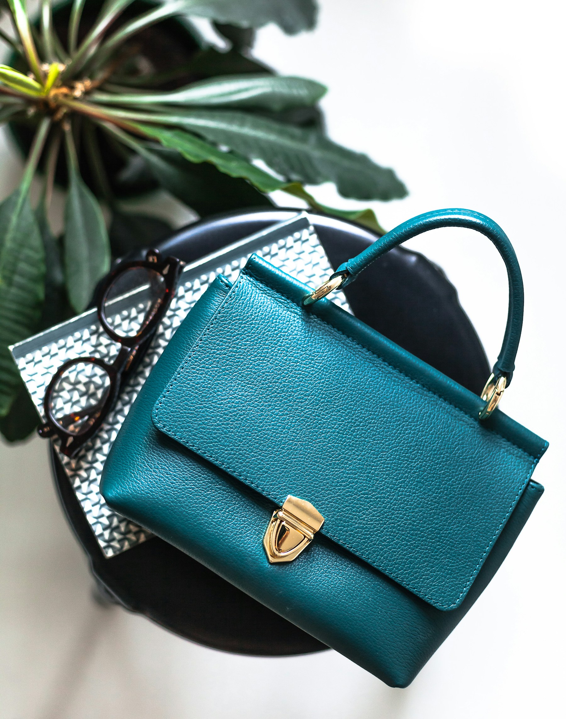 Structured teal handbag in afternoon light