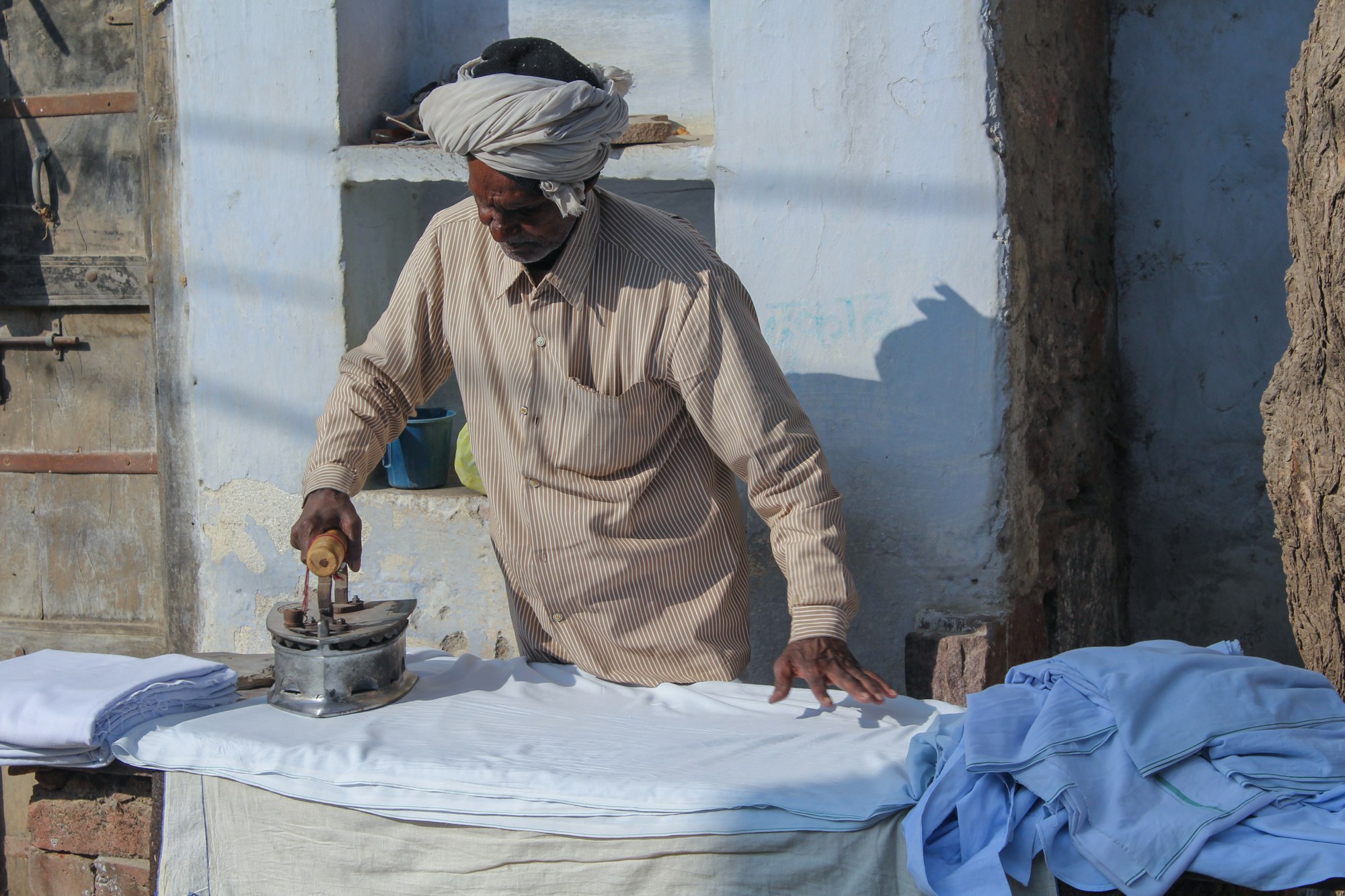 A hand ironing a shirt